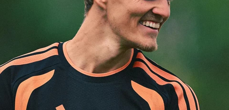 Player in training kit smiling at camera