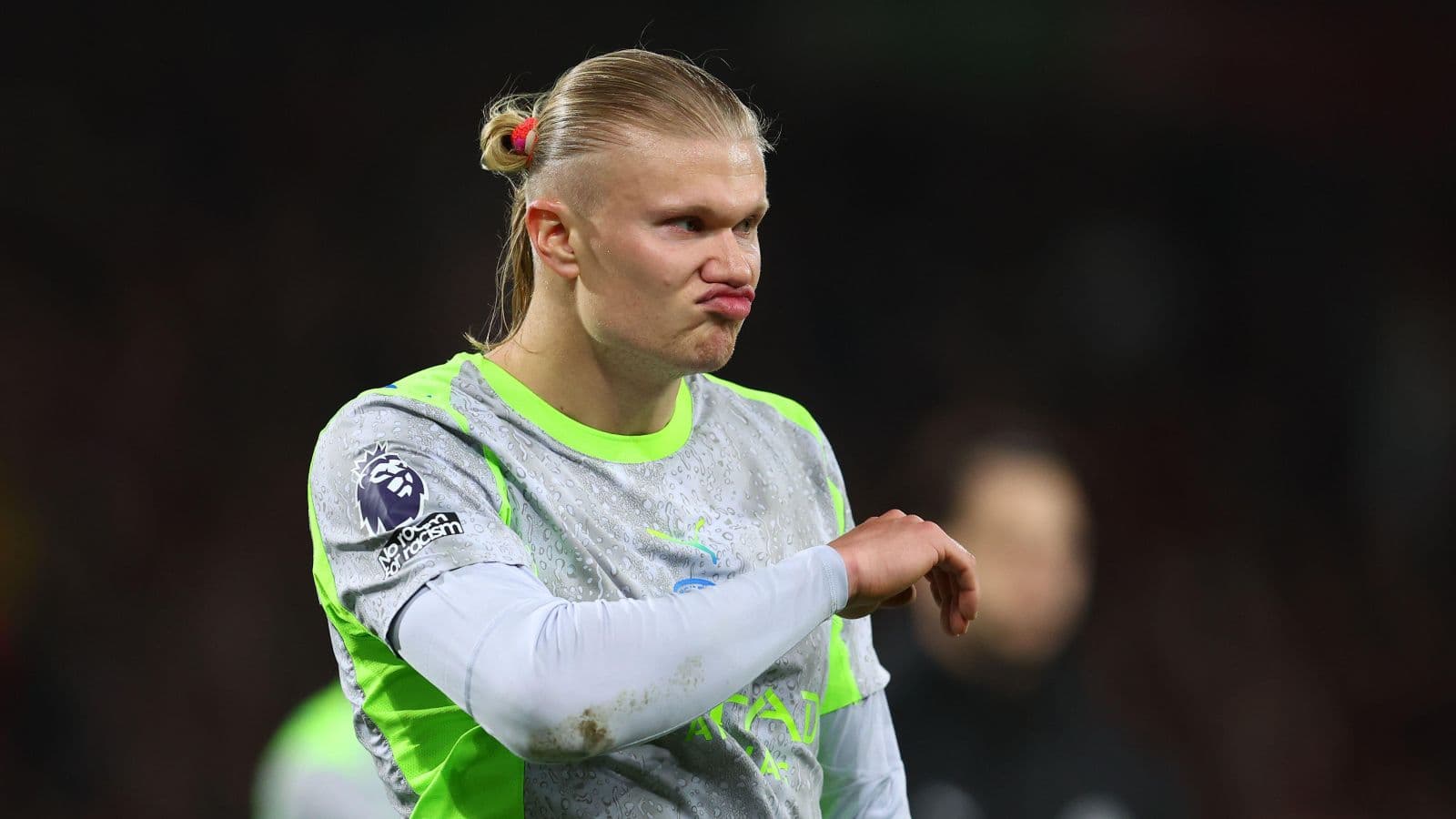 Player in training gear gesturing during match warm-up