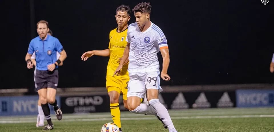 New York City II player dribbling past Columbus Crew II