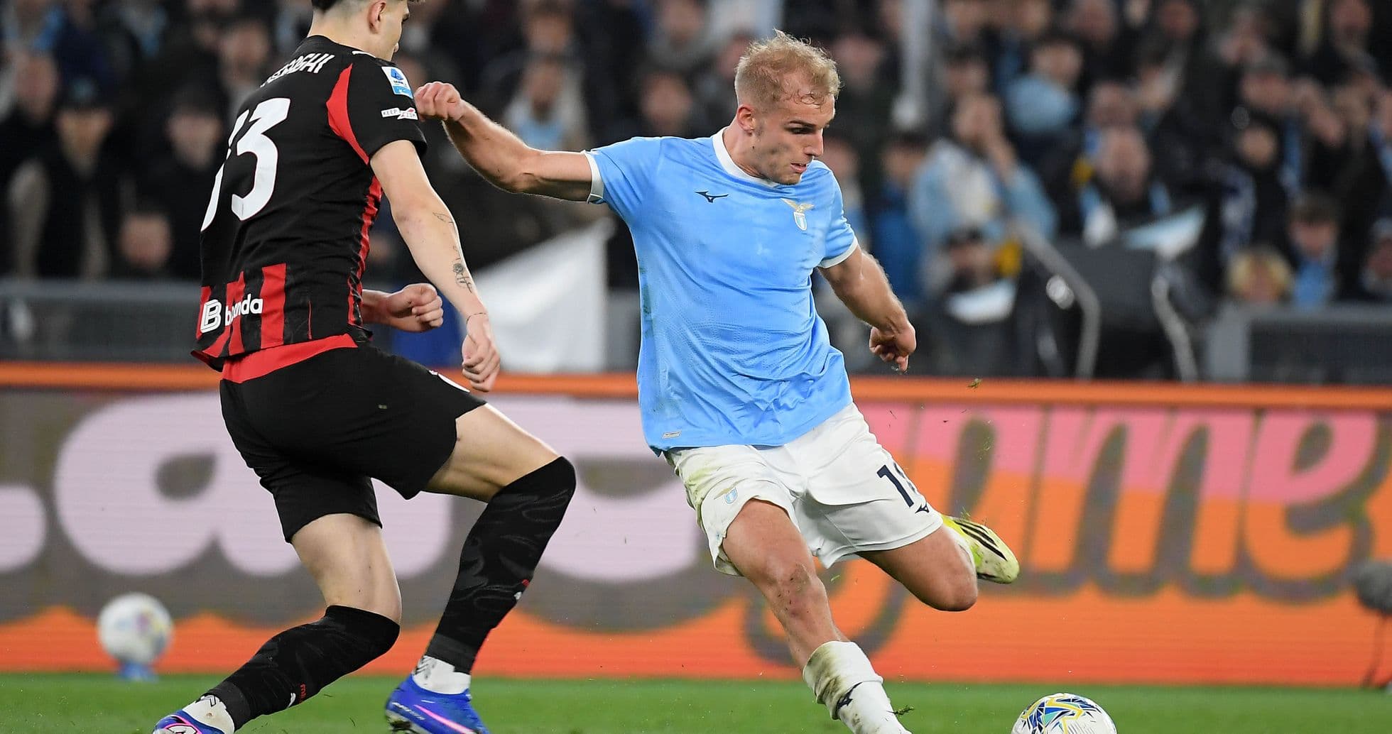 Lazio player dribbling past AC Milan defender