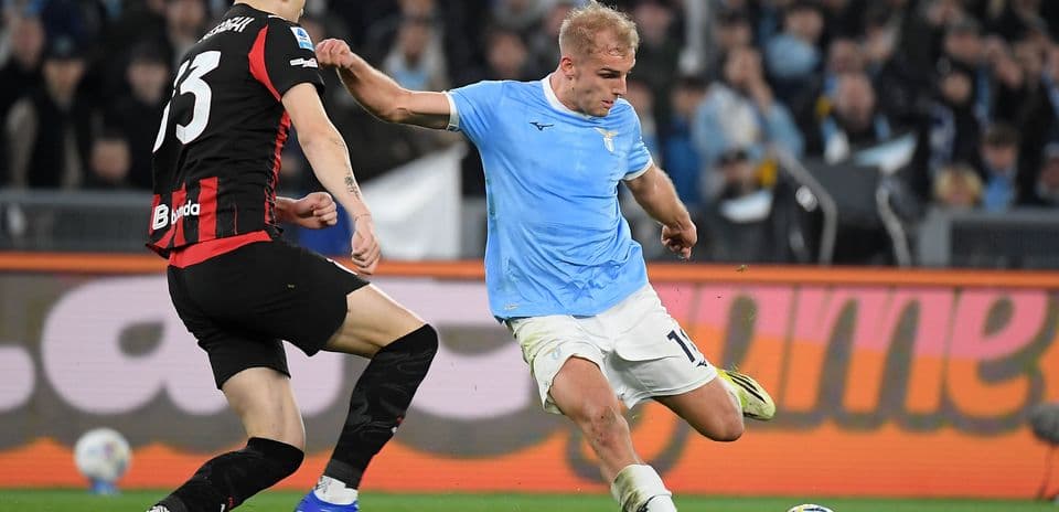 Lazio player dribbling past AC Milan defender