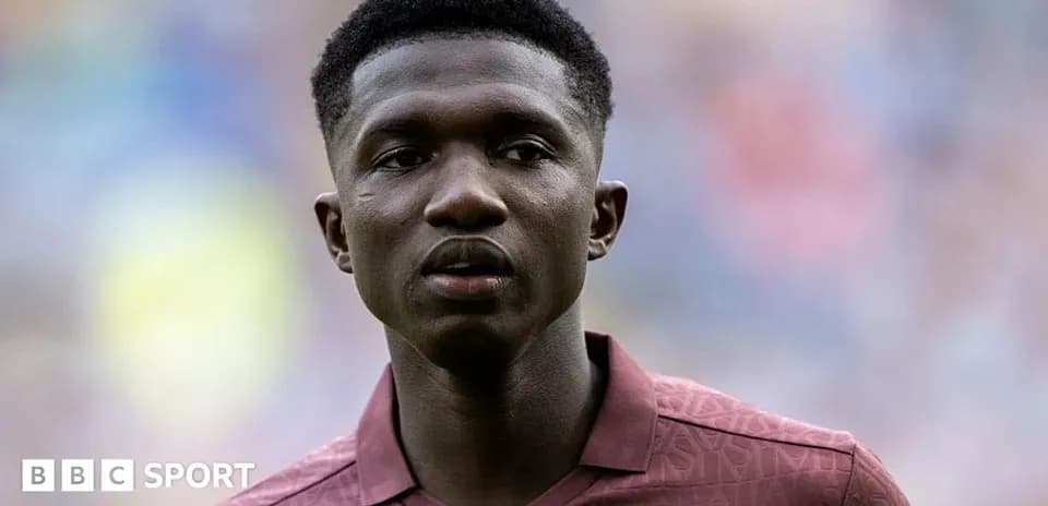 Player in maroon shirt during match warm-up