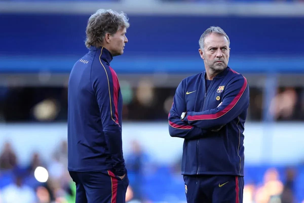 Two coaches discussing strategy on the pitch