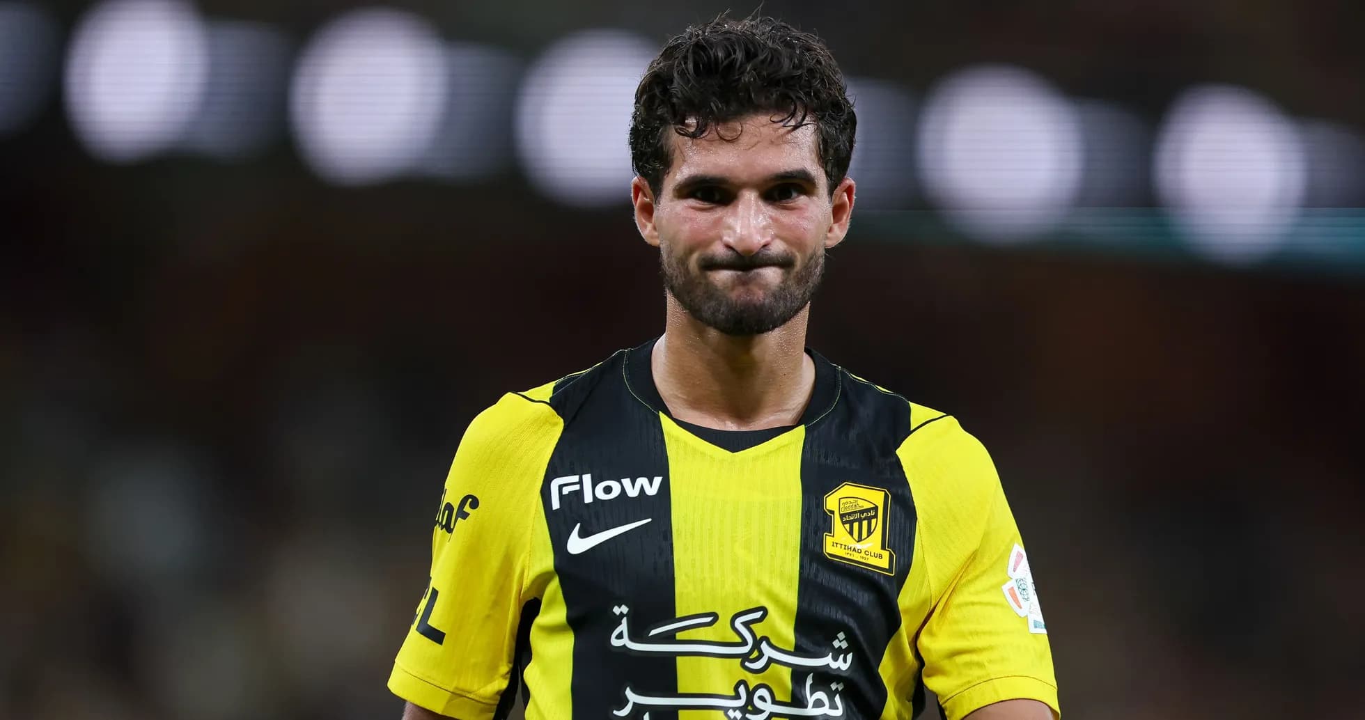 Player in yellow and black jersey on the field