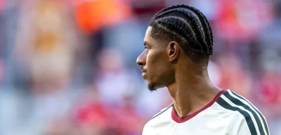 Player with braided hair during match warm-up