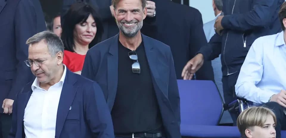 Jurgen Klopp smiling in a stadium setting