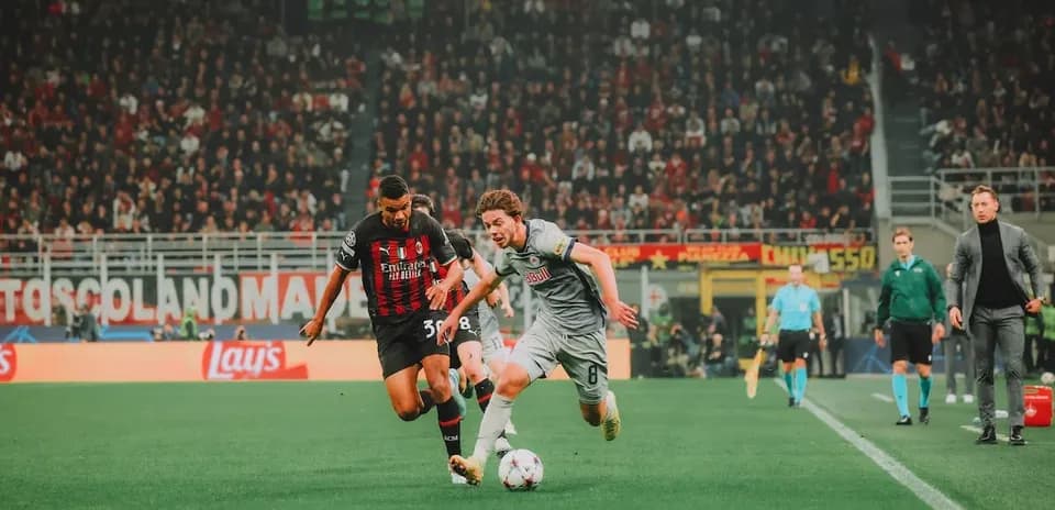 Player tackling during Red Bull Salzburg vs AC Milan match