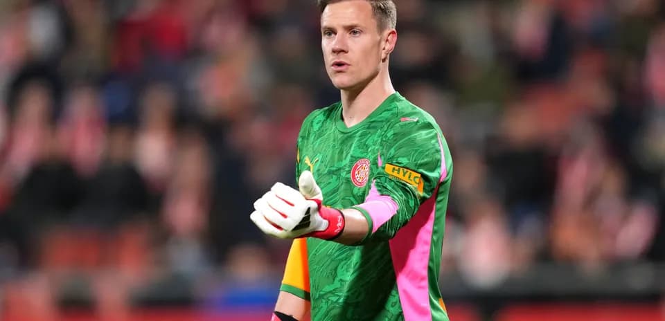 Goalkeeper gesturing during a match in green kit