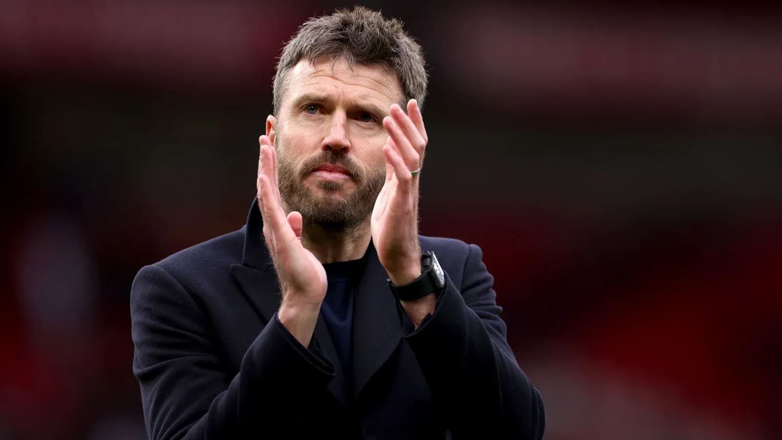 Coach applauding the crowd after the match