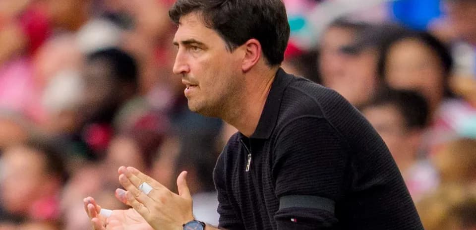 Coach gesturing during a match from the sidelines