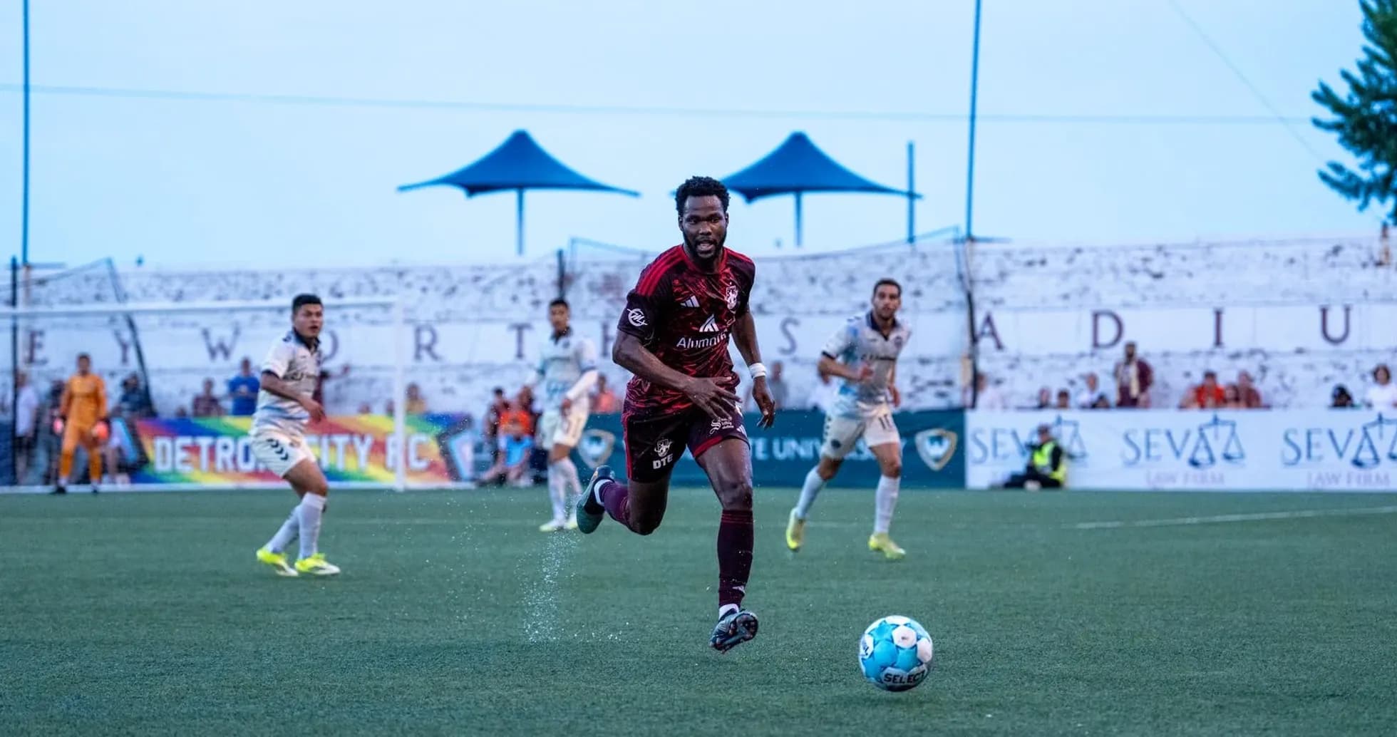 Detroit City player pursuing the ball during match