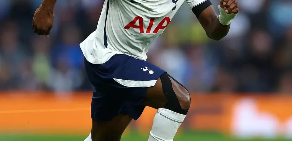Tottenham player sprinting towards the ball on pitch
