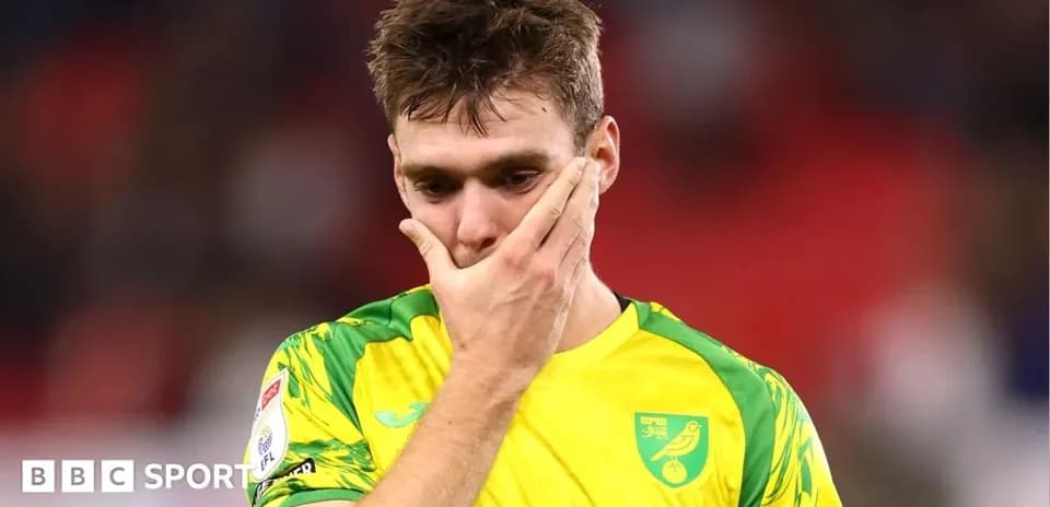 Player in Norwich City kit looking distressed