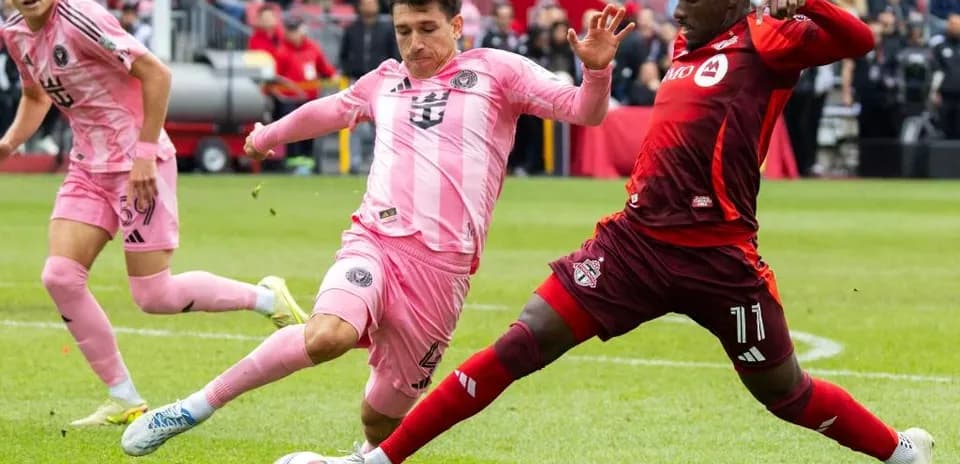 Players competing for the ball in MLS match