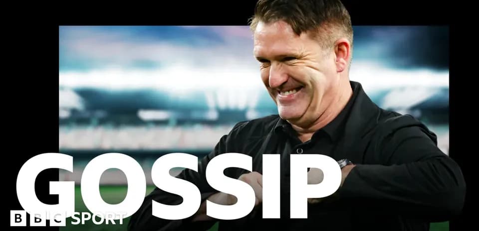 Coach smiling while discussing team news on broadcast