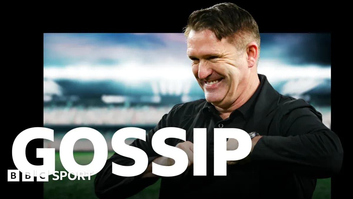 Coach smiling while discussing team news on broadcast