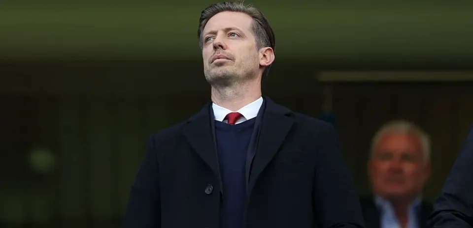 Man in suit observing from stands at stadium