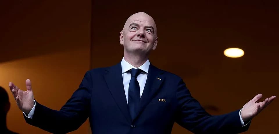 FIFA official speaking with arms raised
