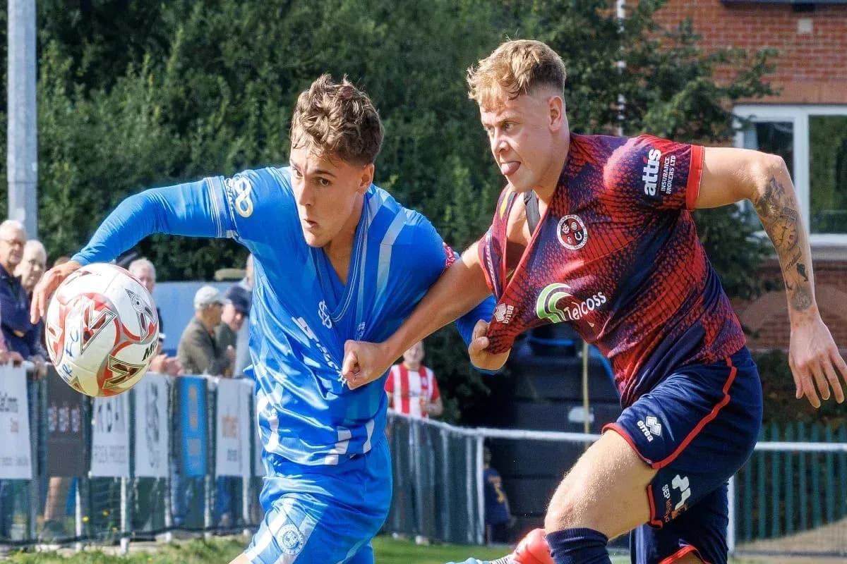 Two players competing for the ball in a match