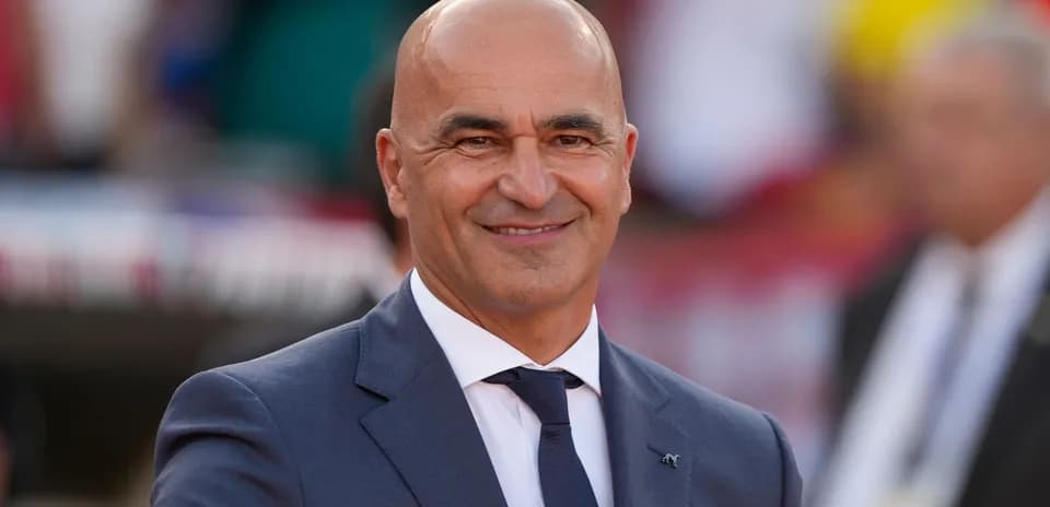 Coach smiling and gesturing during match event