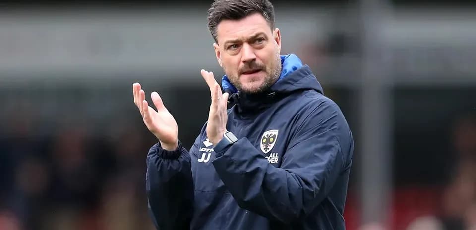 Manager applauding during a football match