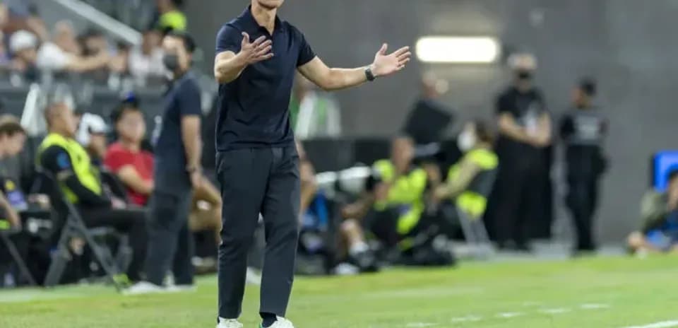Coach gesturing on the sidelines during match