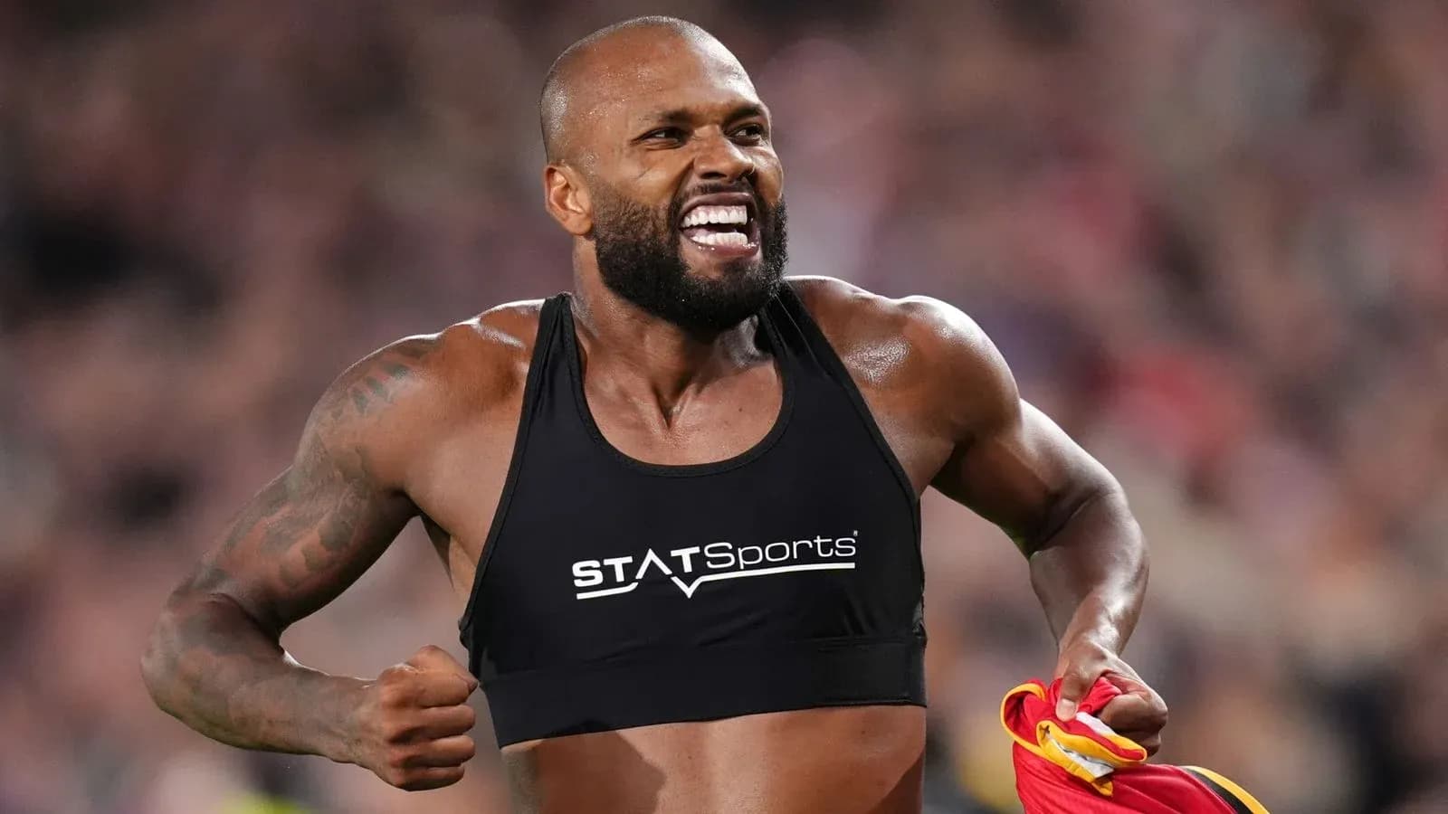 Athlete celebrating with a sports vest after performance