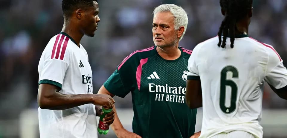 Manager discussing strategy with players during training
