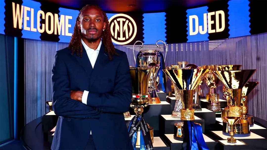 Player posing with trophies at welcome event