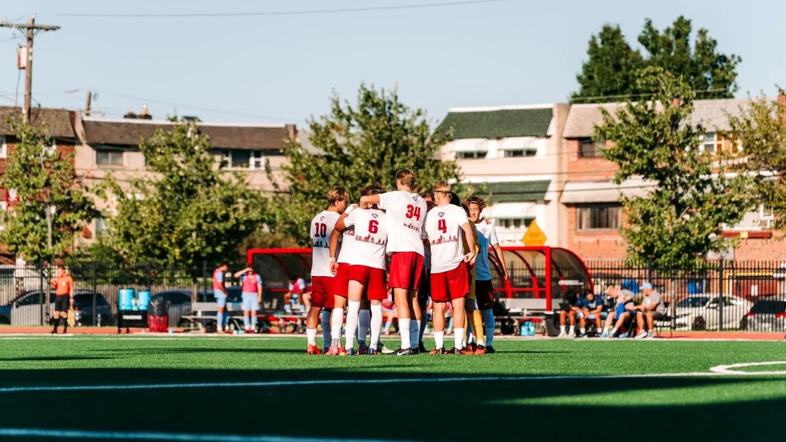 Team huddled together on soccer field before match
