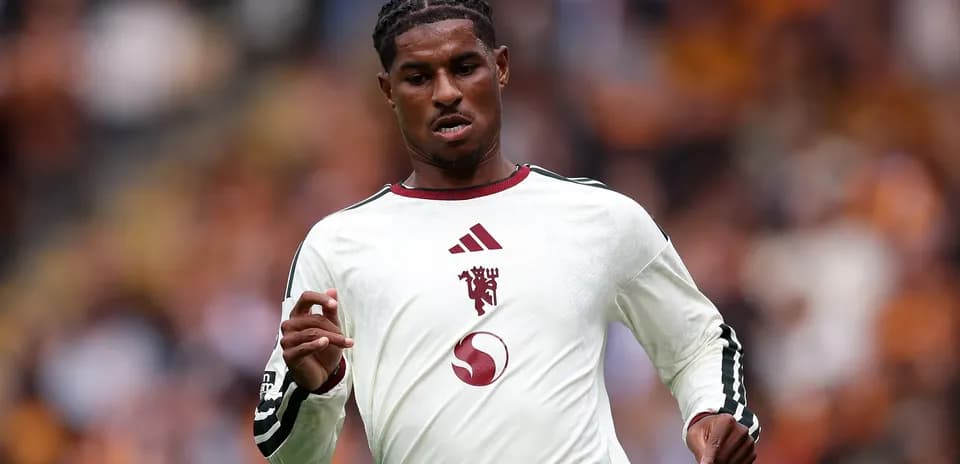 Player running in white team jersey during match