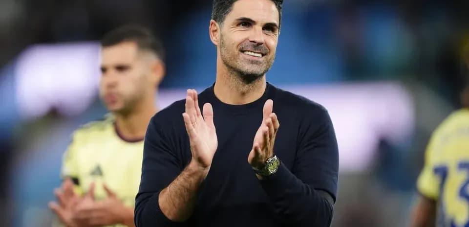 Coach applauding during post-match celebration