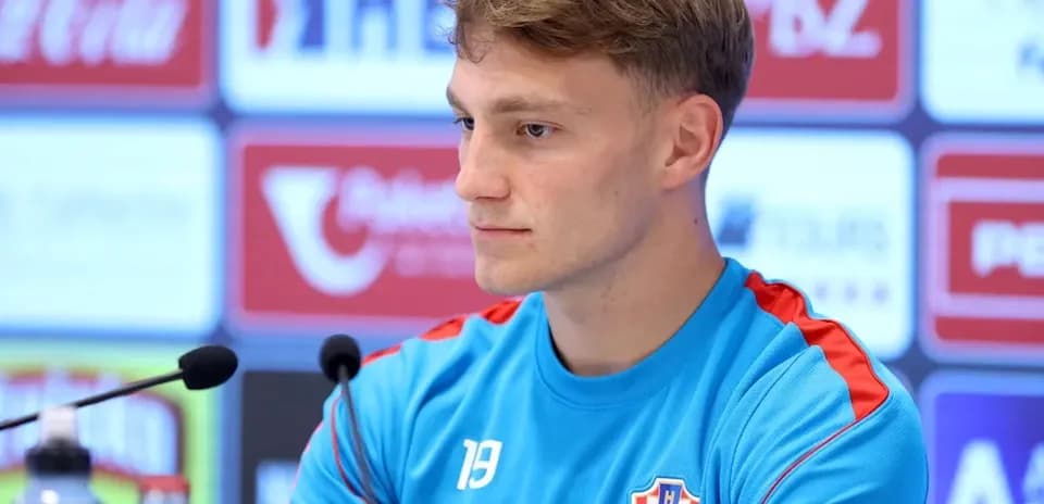 Player at press conference wearing Croatia training jersey