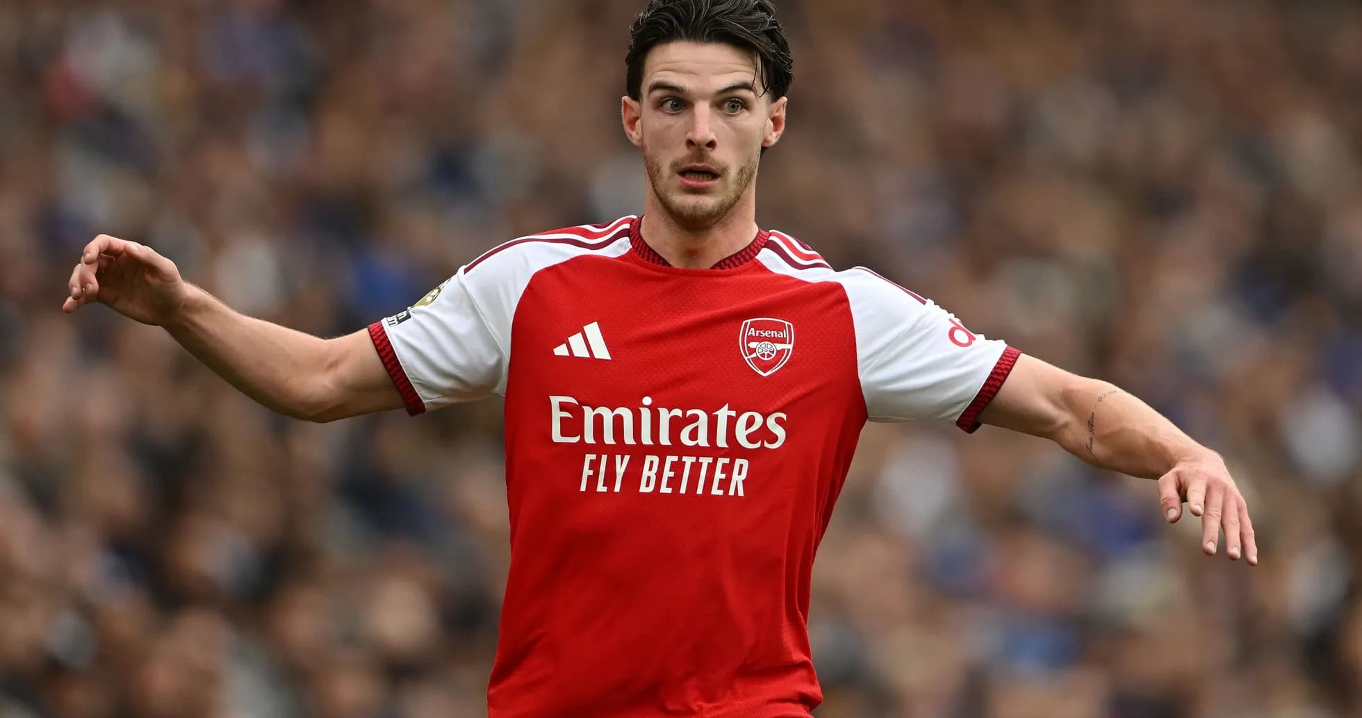 Player in Arsenal kit signaling during match