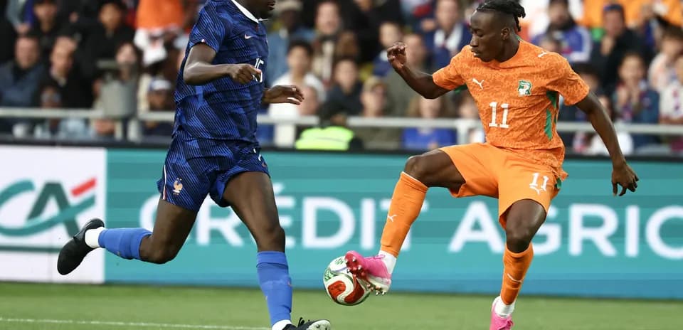 Player from France and Ivory Coast battling for the ball