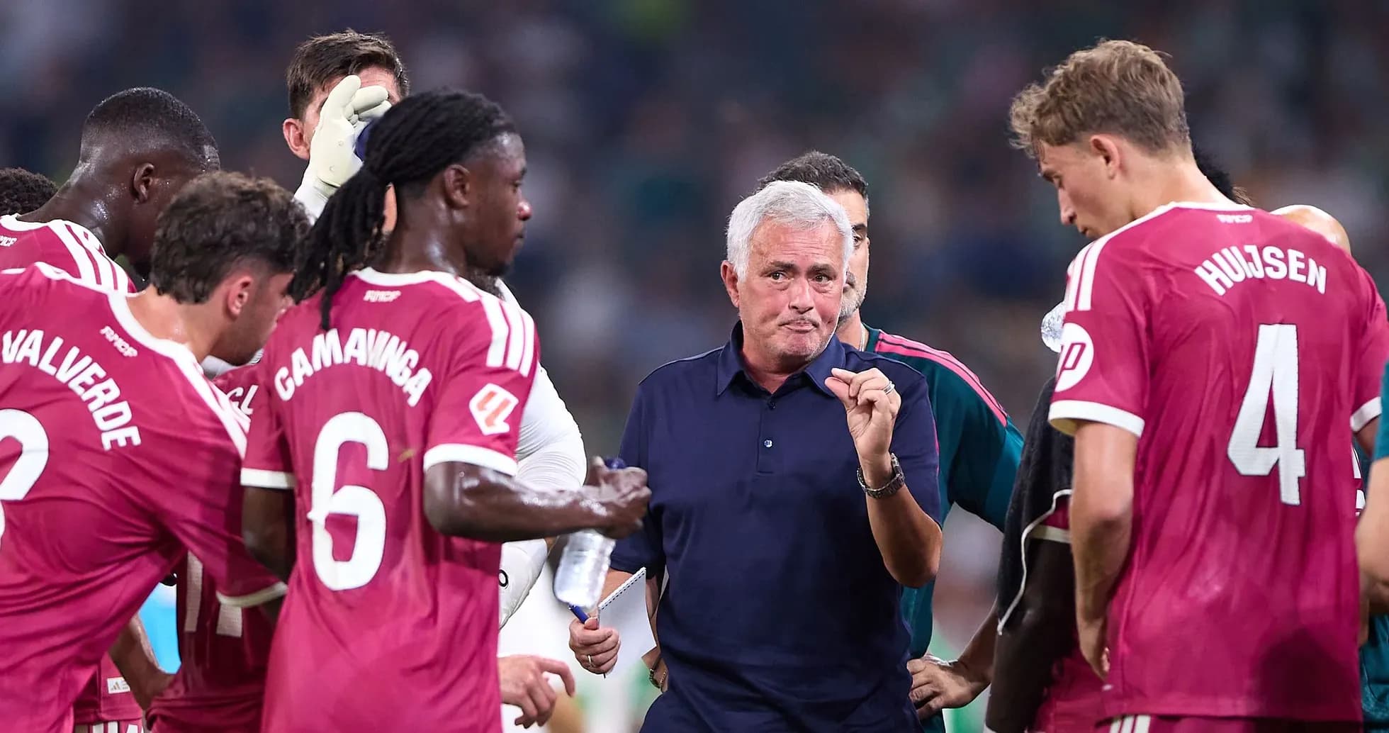 Jose Mourinho discussing strategy with players during match