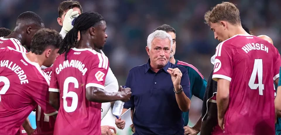 Jose Mourinho discussing strategy with players during match