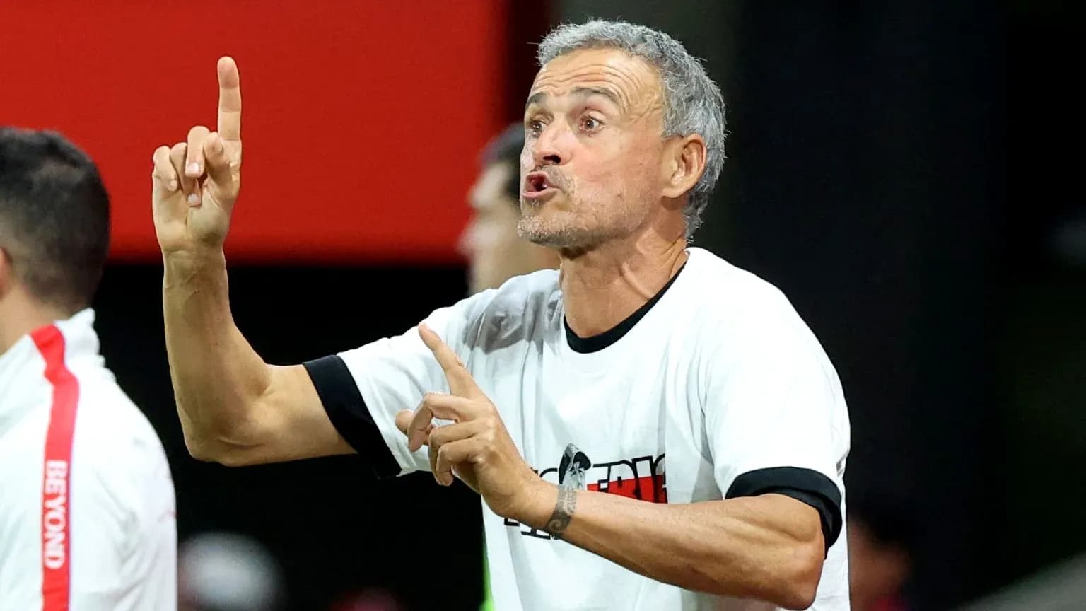 Coach giving instructions on the sidelines