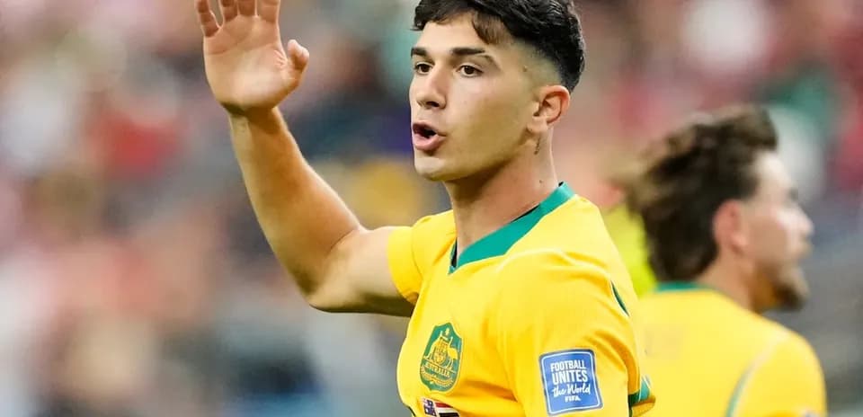 Player gesturing during a soccer match in yellow jersey