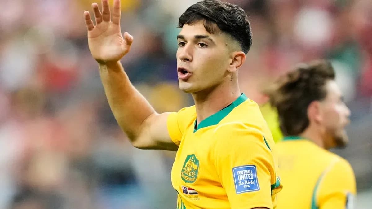 Player gesturing during a soccer match in yellow jersey