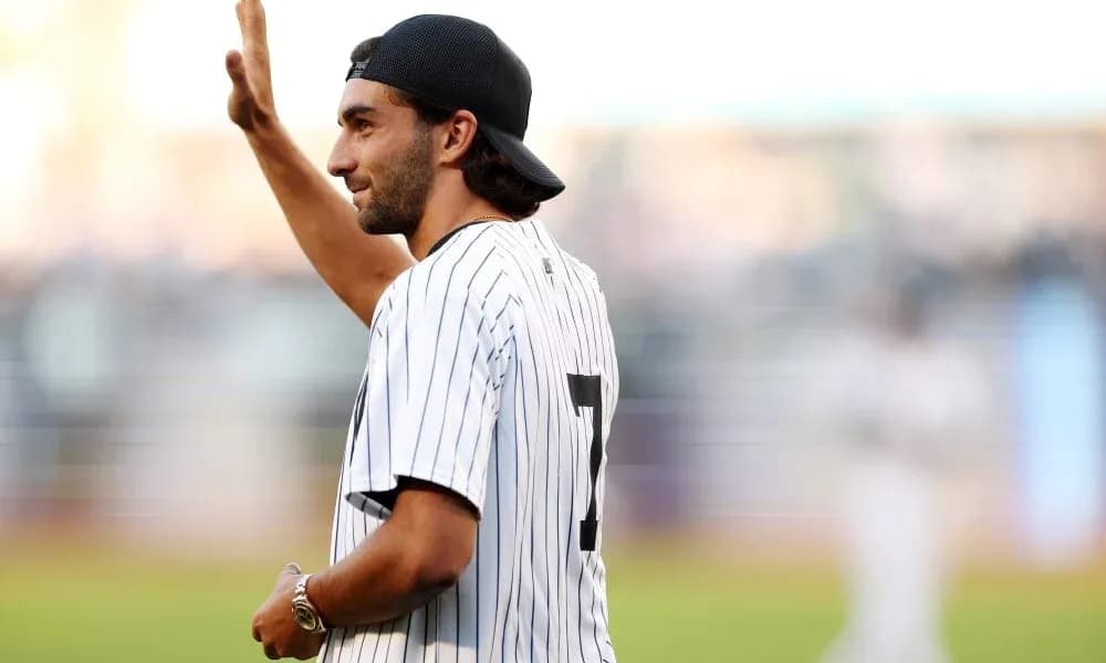 Man in baseball jersey waving to crowd