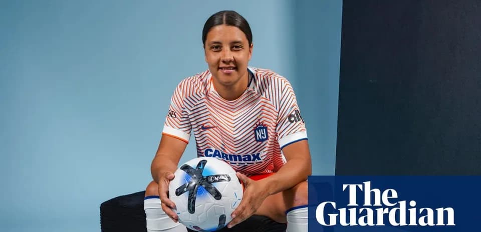 Player posing with soccer ball in team jersey