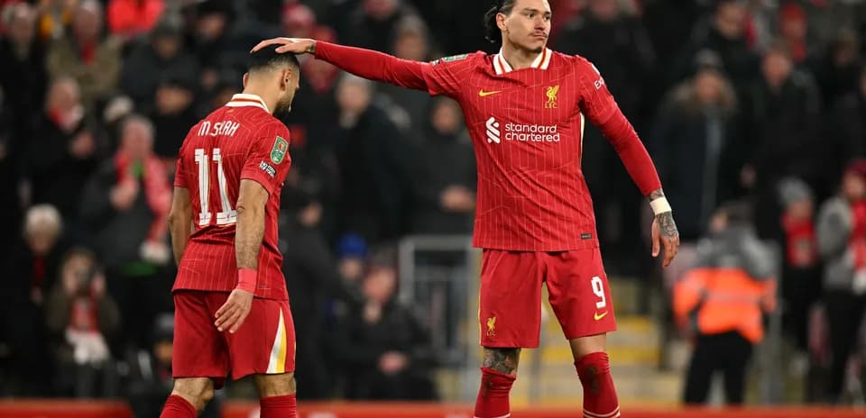 Liverpool players discussing on the pitch during match