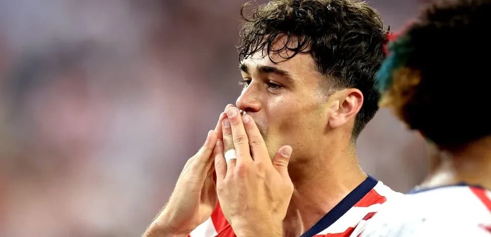 Player celebrating with hands to mouth on field