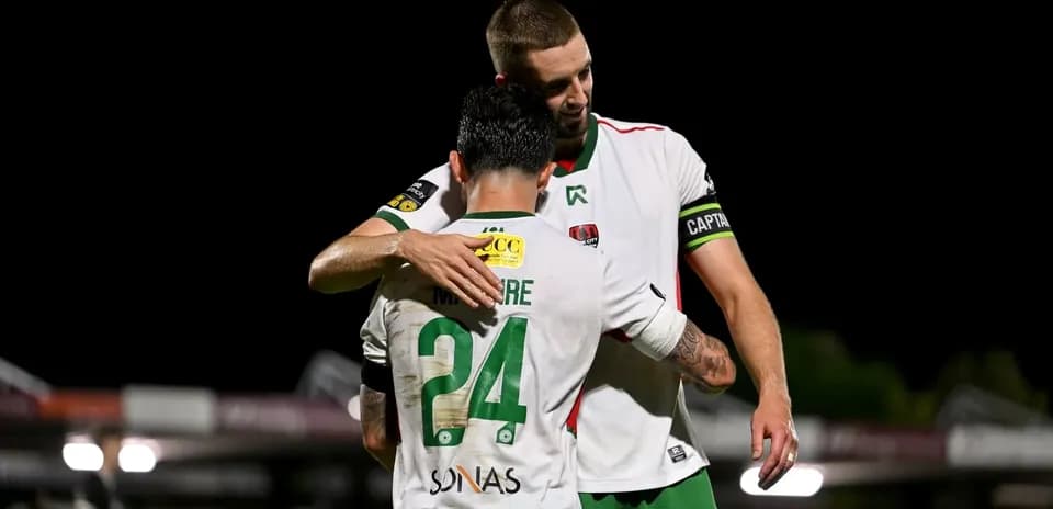 Players embracing on the field after match