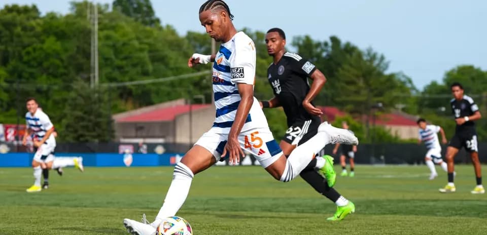 Player kicking ball during Huntsville City match