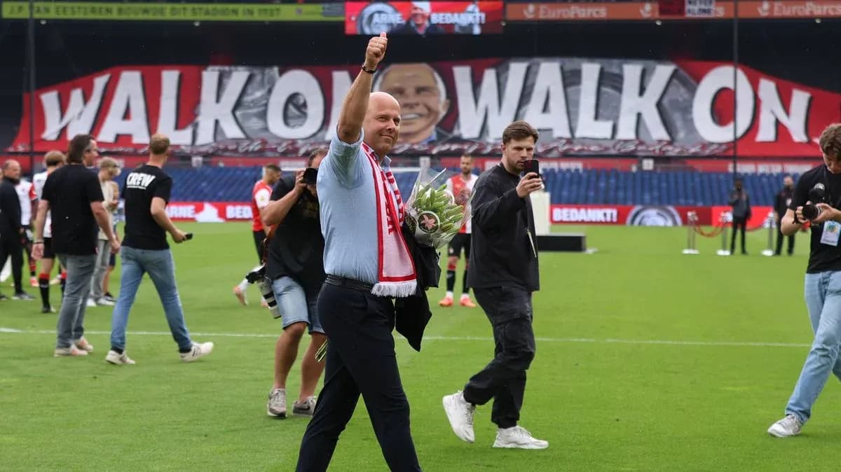Man waving with bouquet in front of large banner