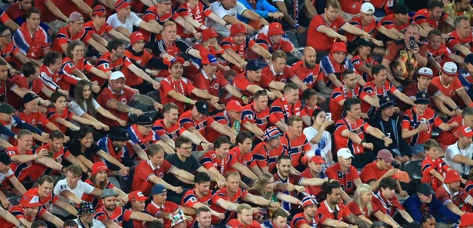 Crowd of fans wearing red jerseys at event