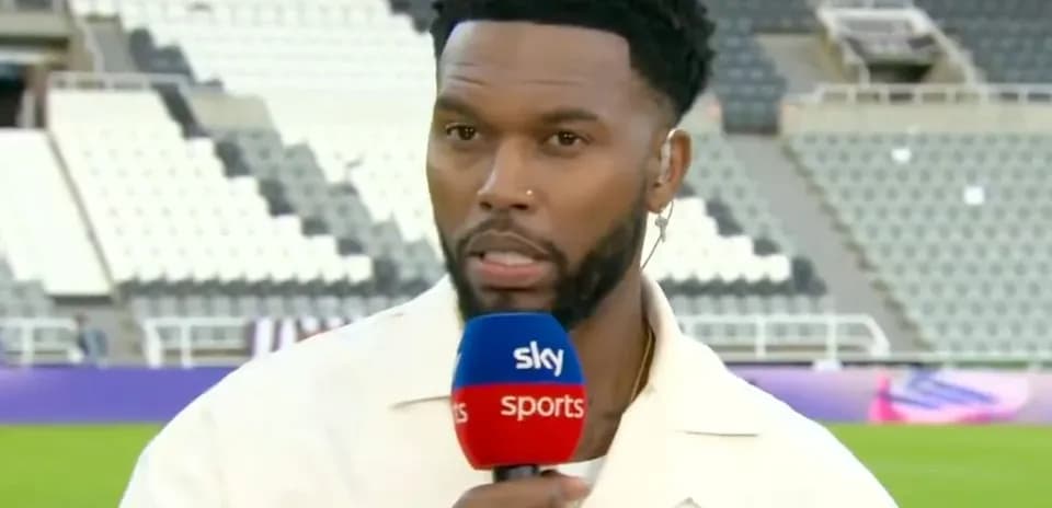 Presenter speaking into microphone on sports field