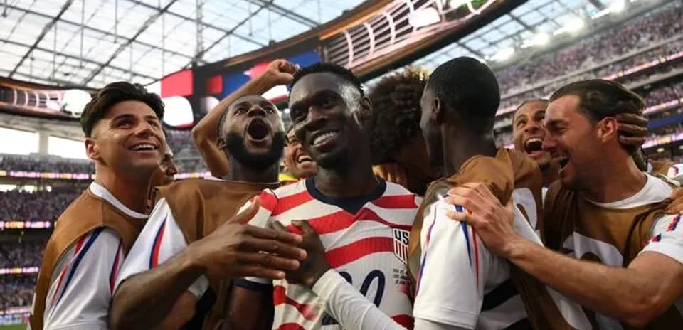 US team celebrating a goal during a match
